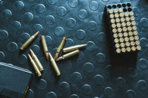 top view of rifle bullets and magazine on table